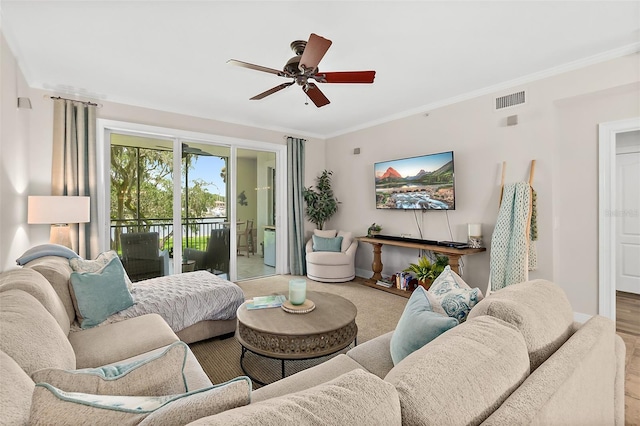 living room with ceiling fan and crown molding