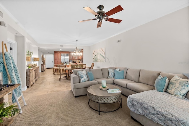 living room with ceiling fan and ornamental molding