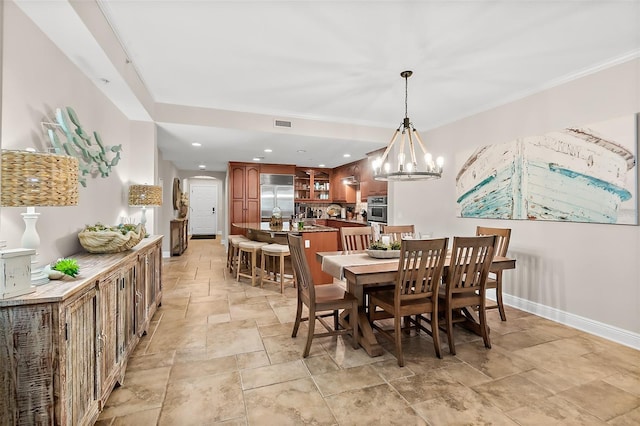 dining room featuring a chandelier and ornamental molding