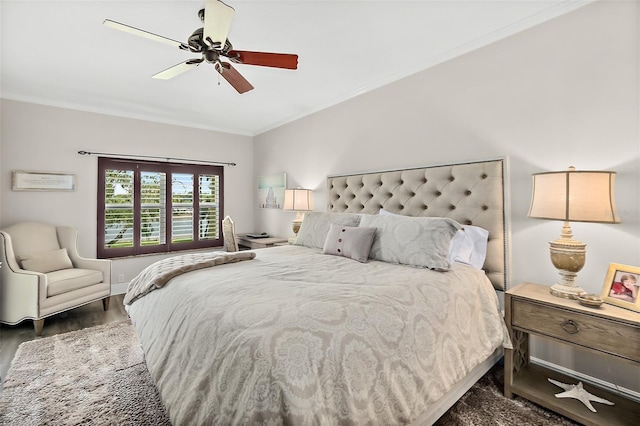 bedroom featuring ceiling fan, dark hardwood / wood-style flooring, and crown molding