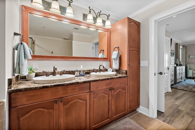 bathroom featuring vanity, ornamental molding, and hardwood / wood-style flooring