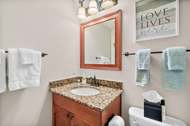 bathroom featuring toilet and vanity