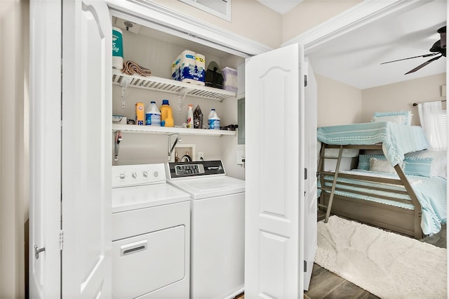 laundry area with ceiling fan, washing machine and dryer, and dark hardwood / wood-style flooring