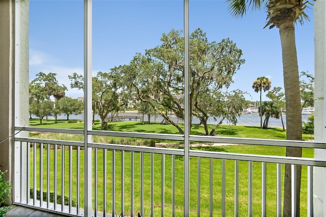 unfurnished sunroom featuring a water view