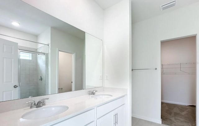 bathroom with a shower with shower door, toilet, tile patterned flooring, and double vanity