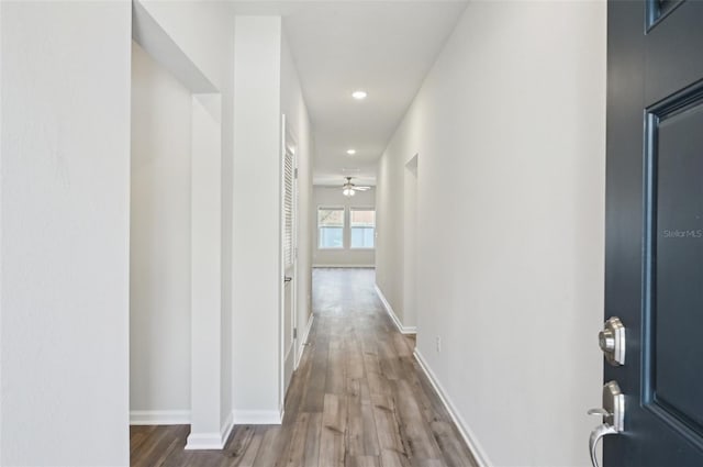 hallway with hardwood / wood-style flooring