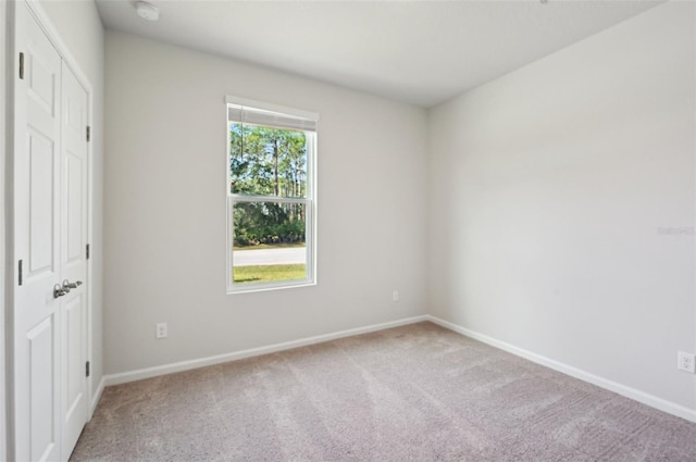 unfurnished bedroom with a closet and carpet flooring