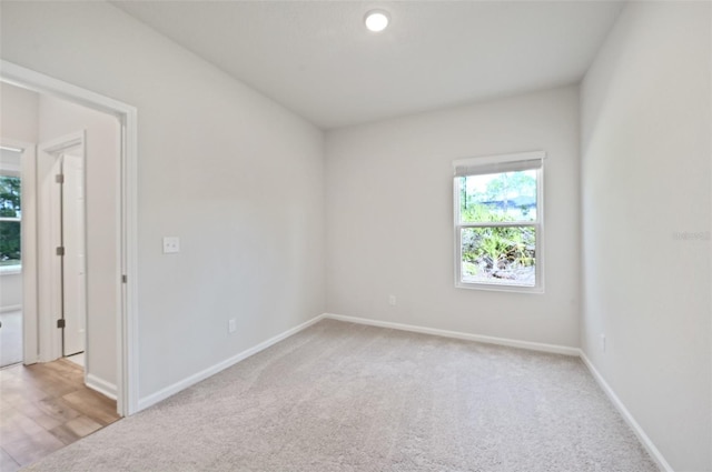 spare room featuring light colored carpet