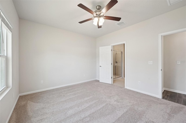 unfurnished bedroom featuring ceiling fan, connected bathroom, and light colored carpet