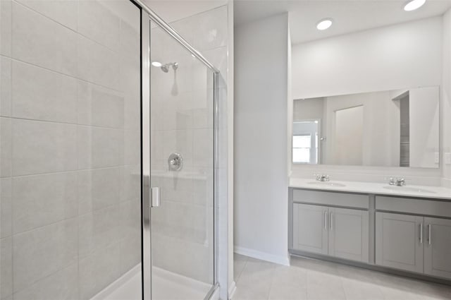 bathroom featuring vanity, tile patterned floors, and walk in shower