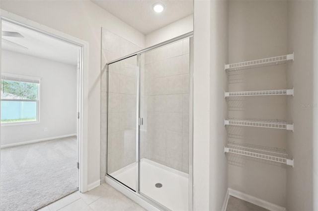 bathroom featuring tile patterned flooring and an enclosed shower