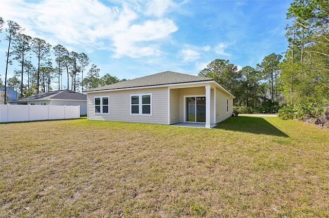 rear view of house with a yard