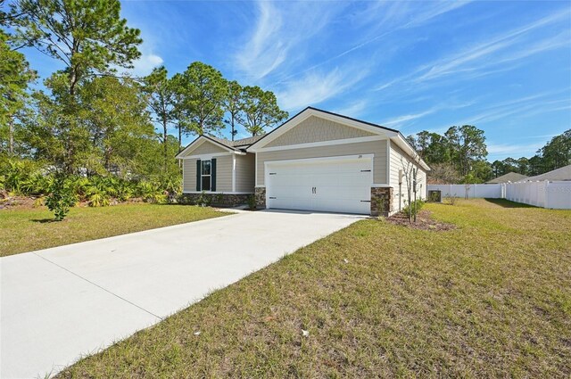 view of front facade featuring a front yard and a garage