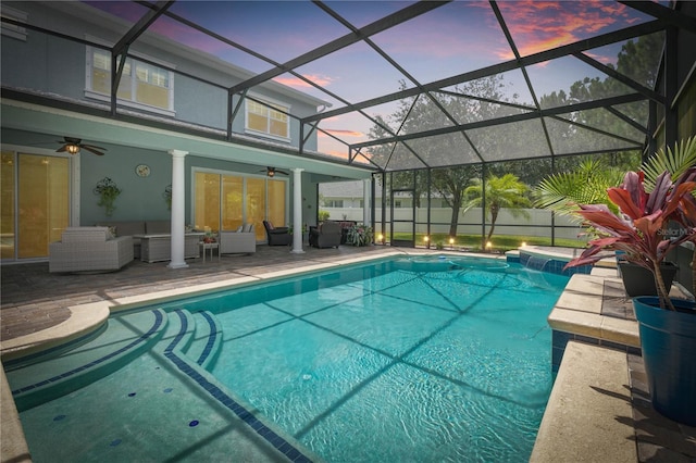 pool at dusk with ceiling fan, a patio, an outdoor hangout area, fence, and a fenced in pool