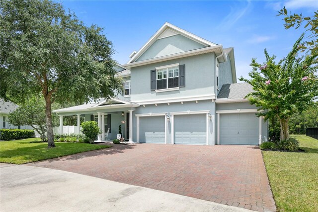 view of front of property with a garage and a front lawn