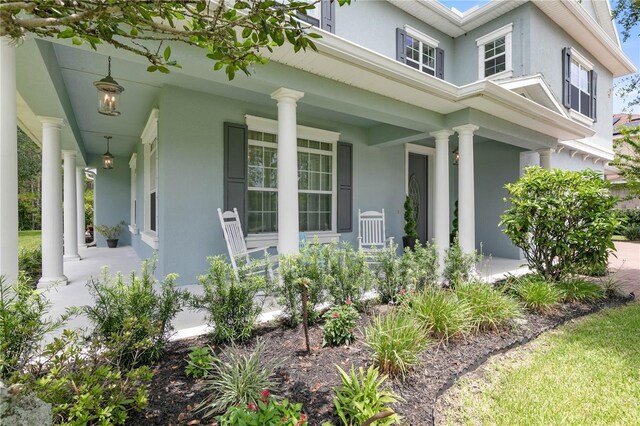 rear view of house featuring covered porch