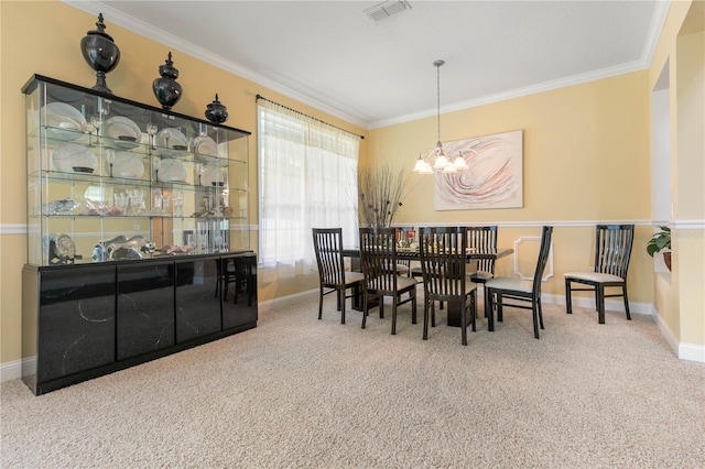 carpeted dining space with crown molding and an inviting chandelier