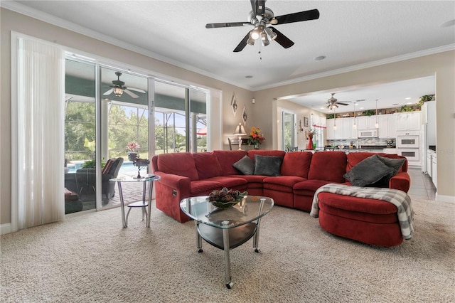 living room with plenty of natural light, crown molding, and ceiling fan