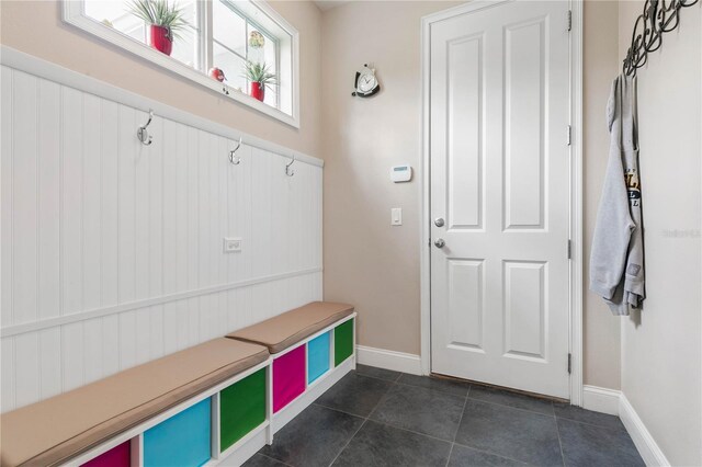 mudroom featuring dark tile patterned floors