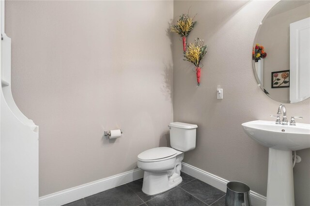 bathroom featuring tile patterned flooring and toilet