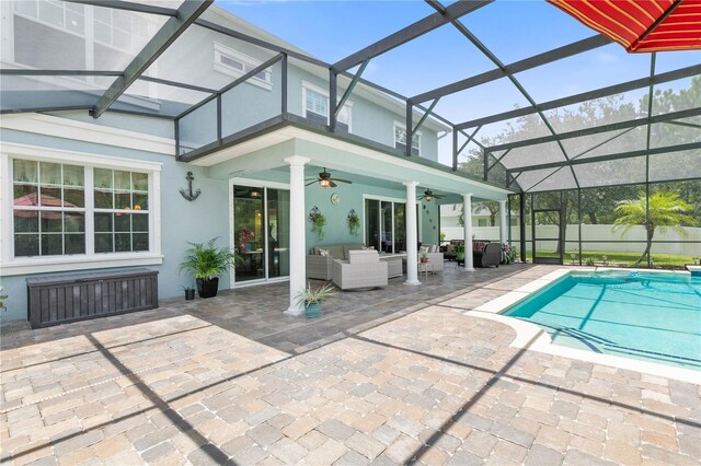 view of pool featuring an outdoor living space, a patio, ceiling fan, and a lanai