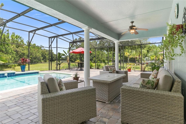 view of patio / terrace featuring an outdoor hangout area, ceiling fan, and glass enclosure