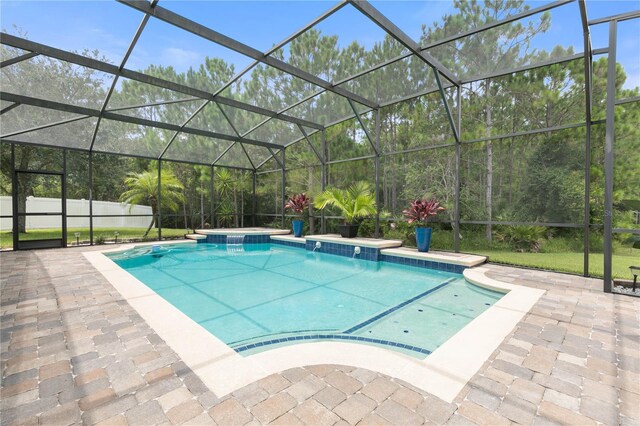 view of pool featuring a patio and glass enclosure