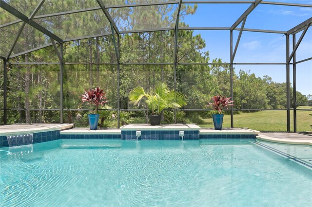 view of swimming pool with pool water feature and a lanai