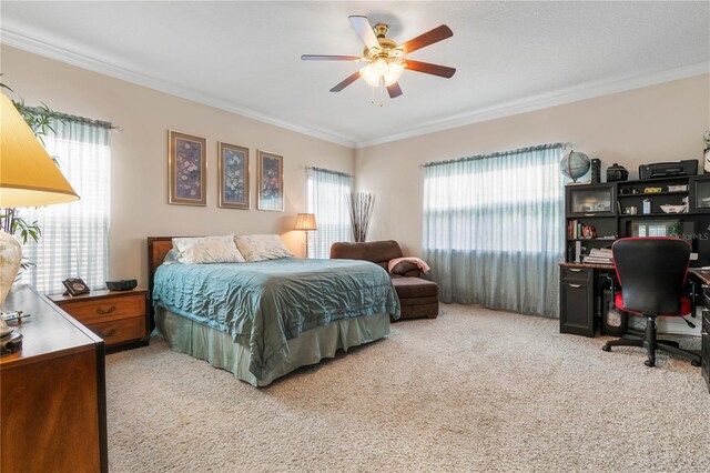 carpeted bedroom featuring ornamental molding and ceiling fan