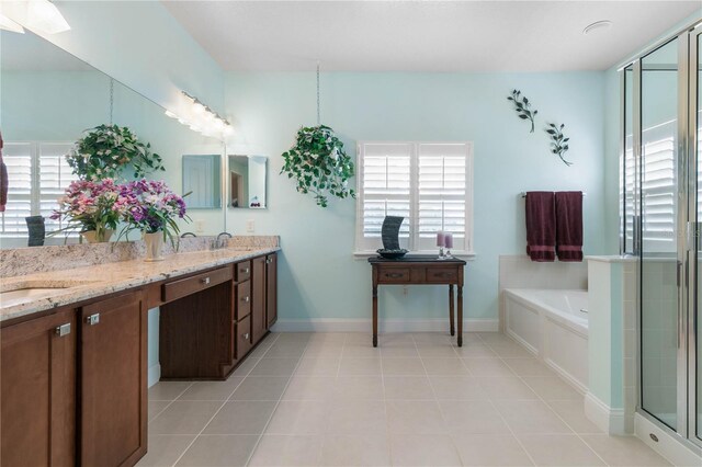 bathroom with tile patterned flooring, separate shower and tub, a healthy amount of sunlight, and dual bowl vanity