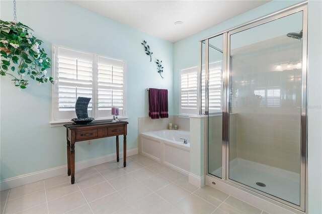 bathroom featuring independent shower and bath and tile patterned flooring