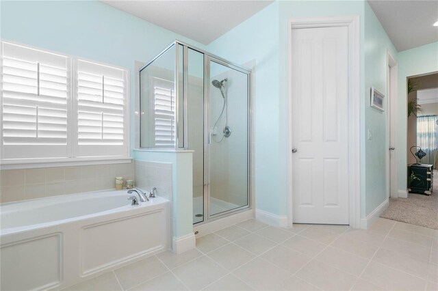 bathroom featuring independent shower and bath and tile patterned flooring