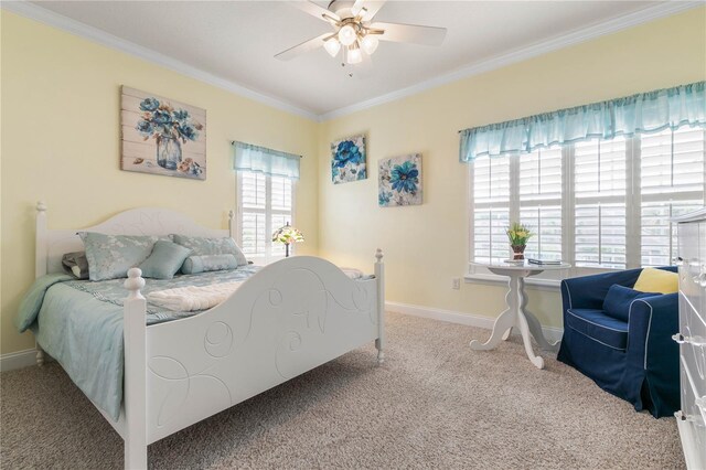 carpeted bedroom with ceiling fan and crown molding