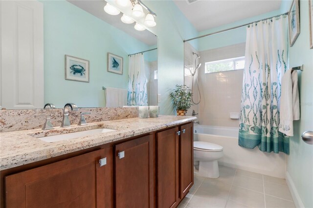 full bathroom with tile patterned floors, vanity, toilet, and shower / bathtub combination with curtain