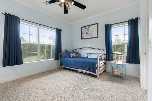 bedroom featuring crown molding, carpet, and ceiling fan