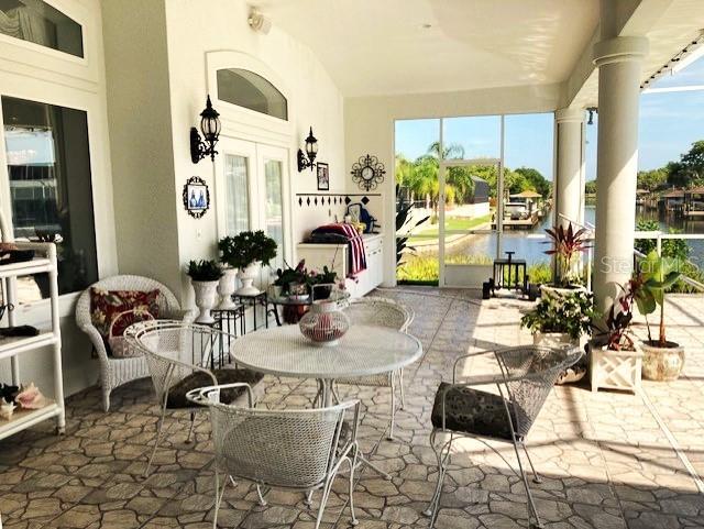 view of patio featuring a water view and french doors