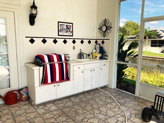 interior space featuring sink and light tile patterned floors