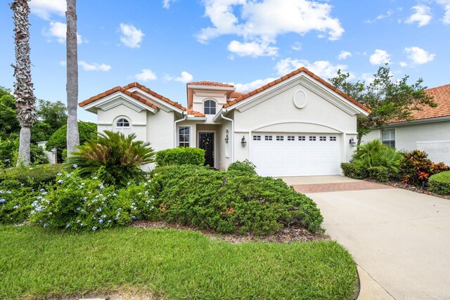 mediterranean / spanish house featuring a garage