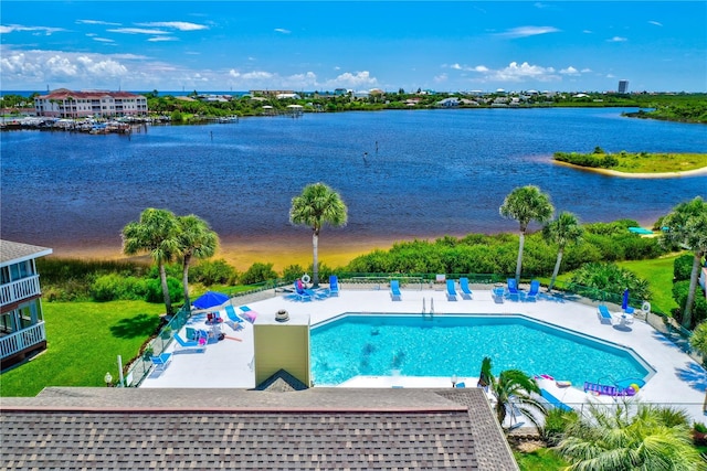 view of pool featuring a water view and a patio area