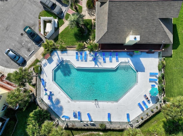 view of pool with a lawn