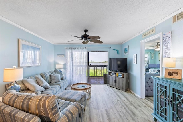 living room featuring a textured ceiling, hardwood / wood-style flooring, crown molding, and ceiling fan