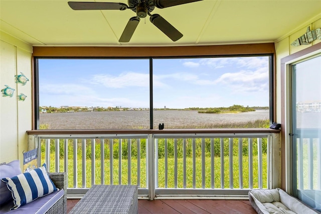 unfurnished sunroom featuring ceiling fan