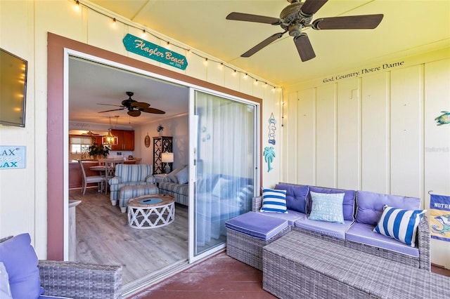 wooden deck featuring an outdoor living space and ceiling fan