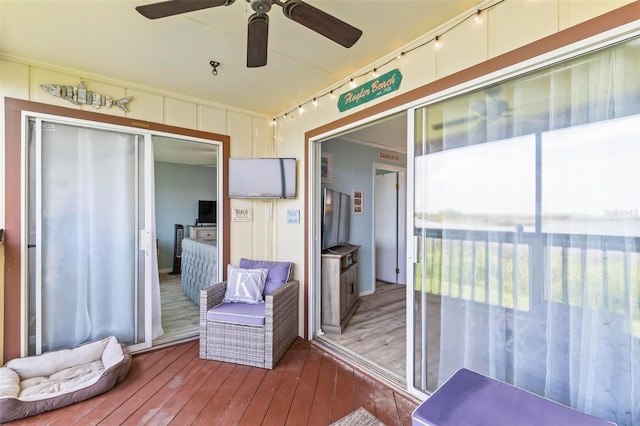 unfurnished sunroom featuring ceiling fan and track lighting