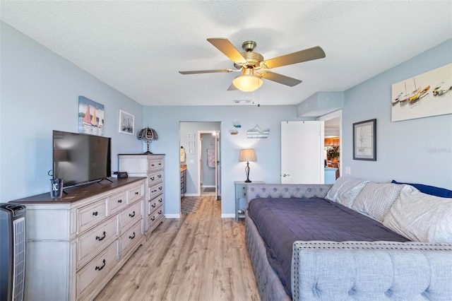 bedroom with ceiling fan, a textured ceiling, and light hardwood / wood-style flooring