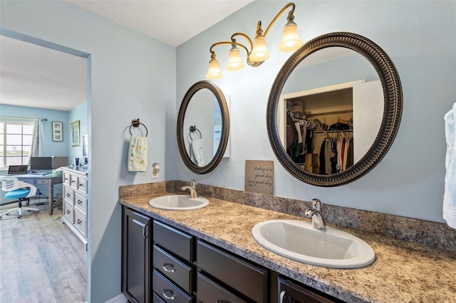 bathroom with hardwood / wood-style flooring and double sink vanity