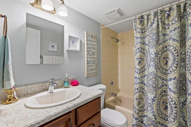 full bathroom with vanity, toilet, a textured ceiling, and shower / bath combo