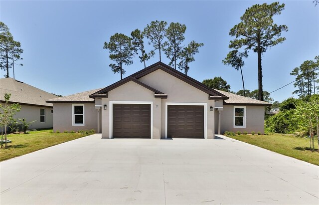 ranch-style home featuring a garage and a front yard