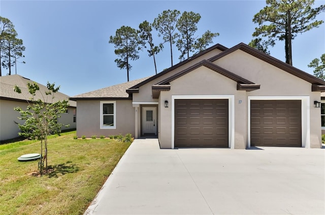 ranch-style house featuring a garage and a front lawn