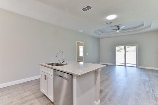 kitchen with ceiling fan, sink, dishwasher, a raised ceiling, and light hardwood / wood-style flooring